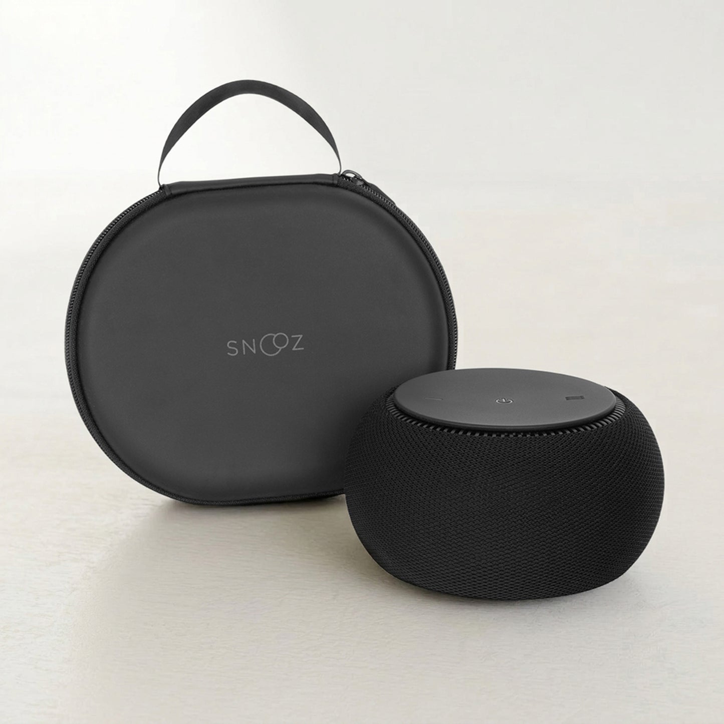 Black portable speaker with carrying case on a light background
