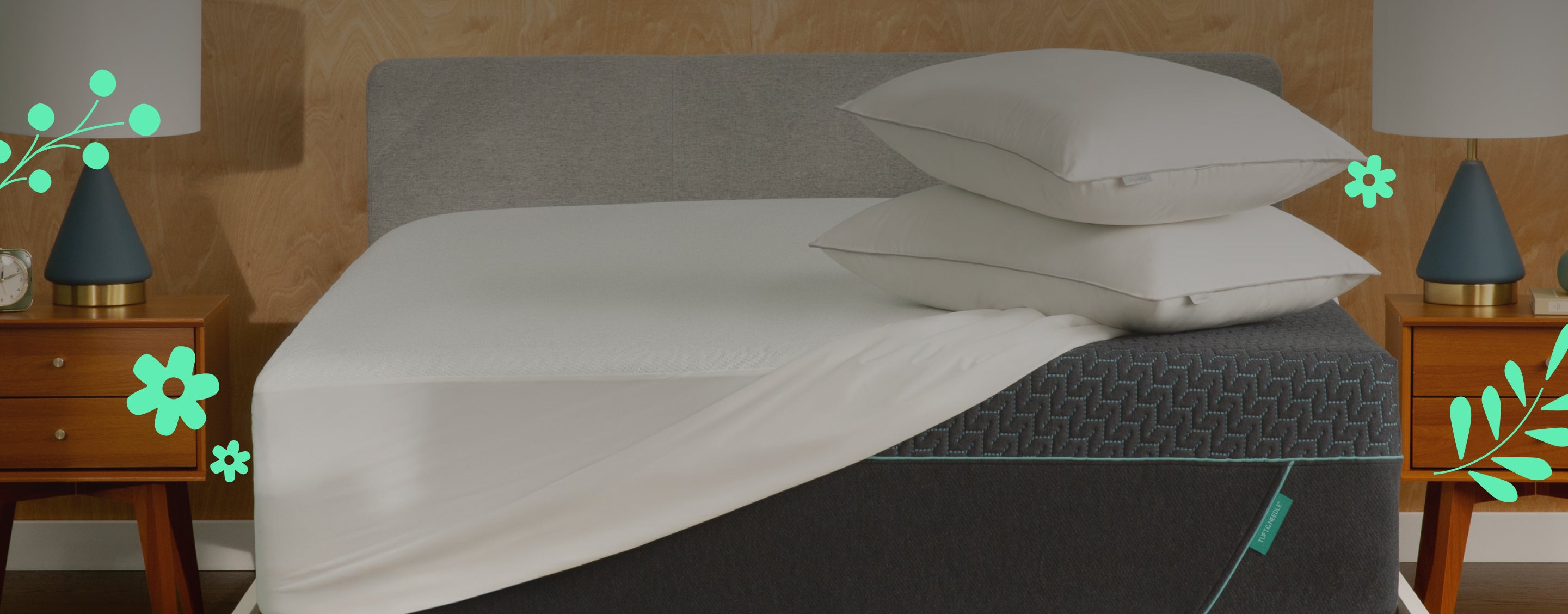 Tuft and Needle Mint mattress with white bedding and gray headboard in a bedroom setting