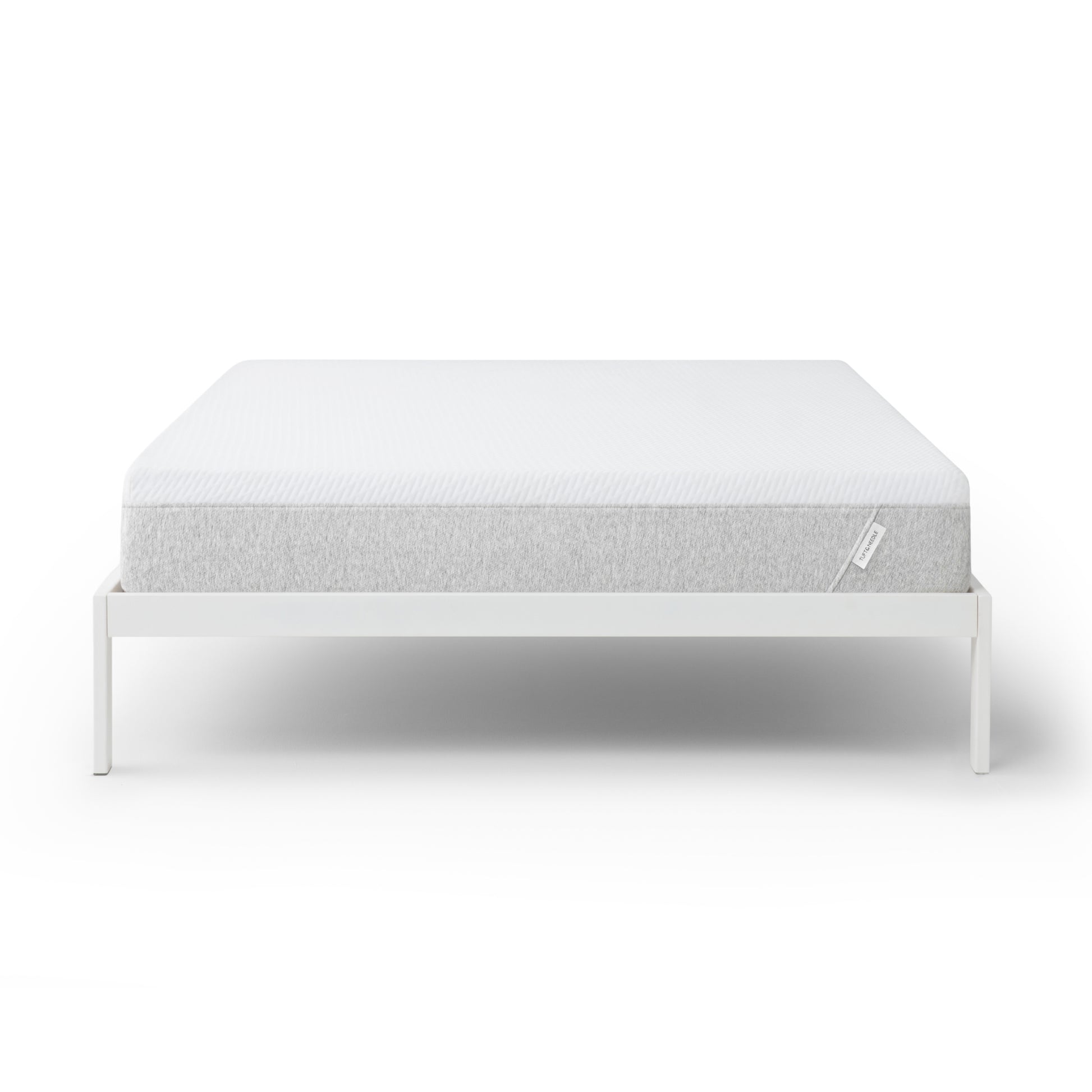 Tuft and Needle Original mattress on a white bed frame against a white background