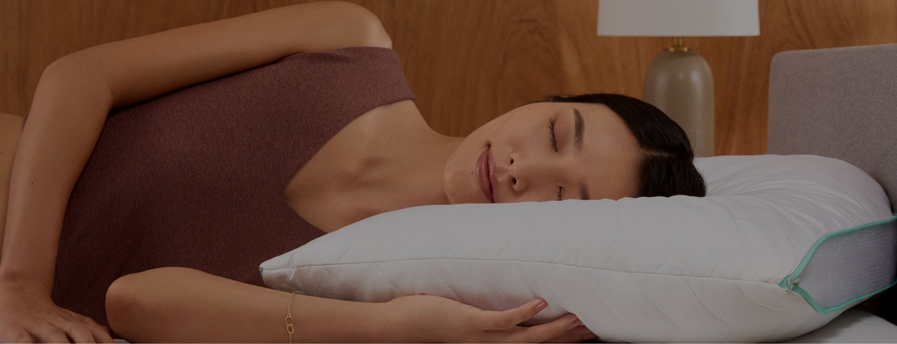 Woman laying on a Tuft and Needle Zip Comfort pillow