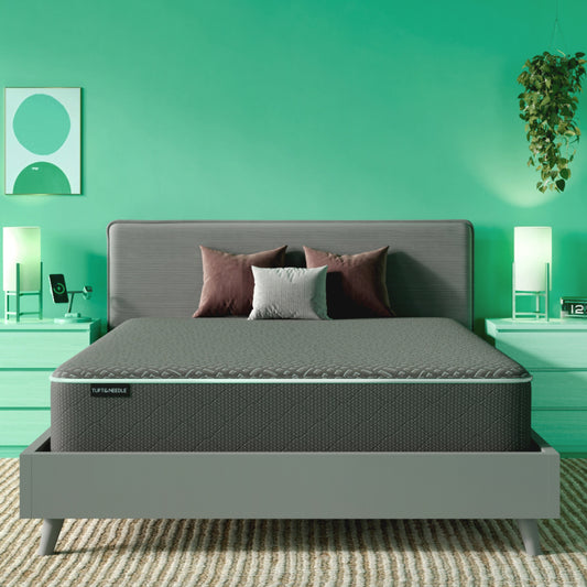 The Tuft and Needle Mint Mattress II in a green bedroom