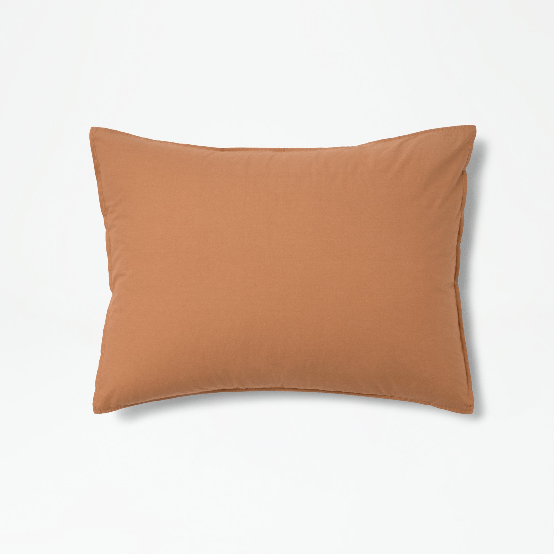 The Tuft and Needle Percale Duvet Cover Set on a pillow ||color:canyon