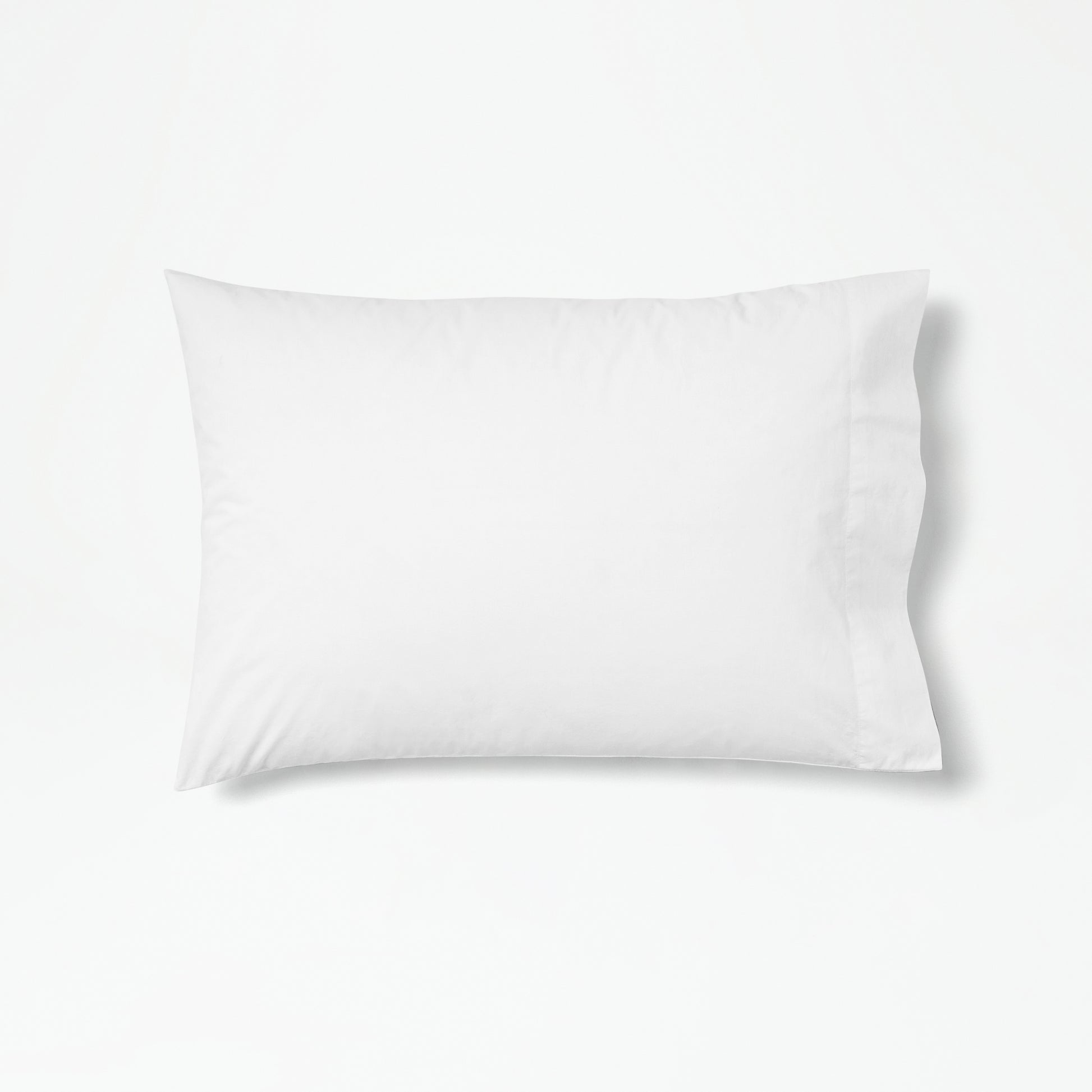 The Tuft and Needle Percale Pillowcase Set on one pillow||color:cloud