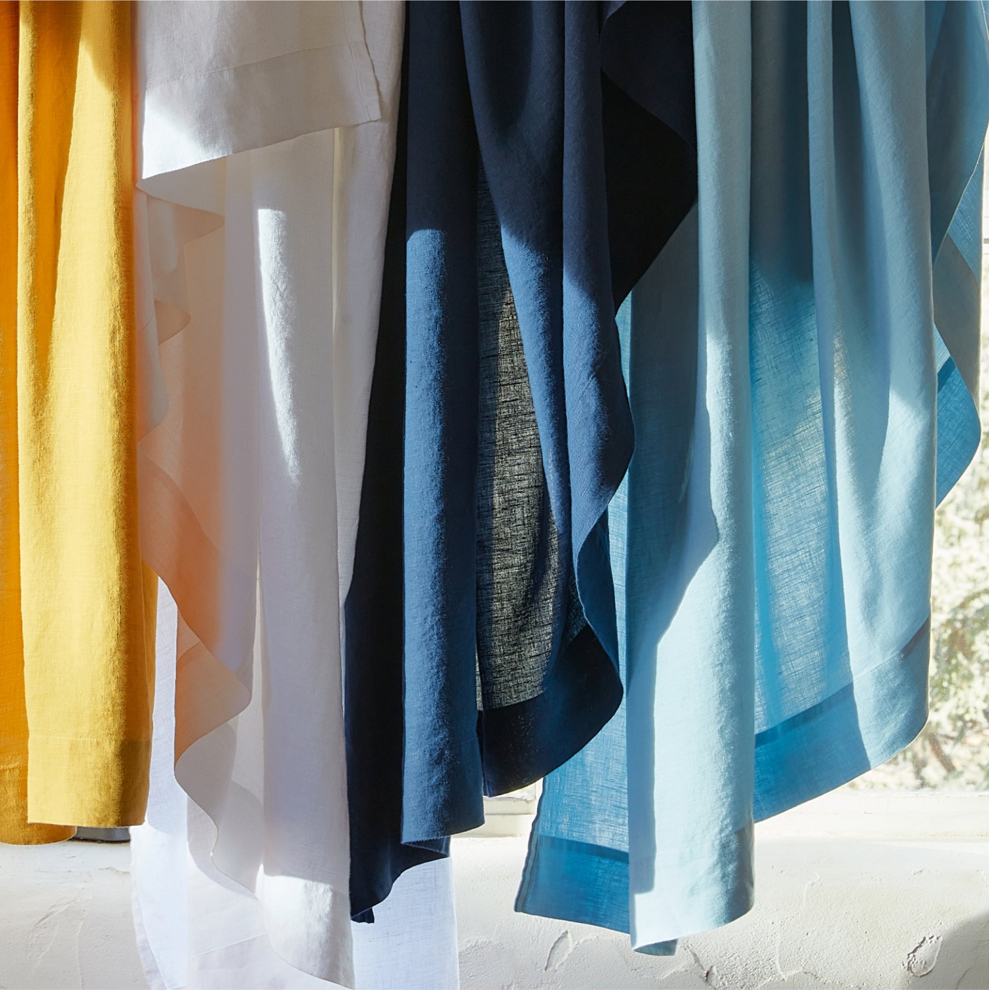 Hanging hemp sheets in an array of colors. 