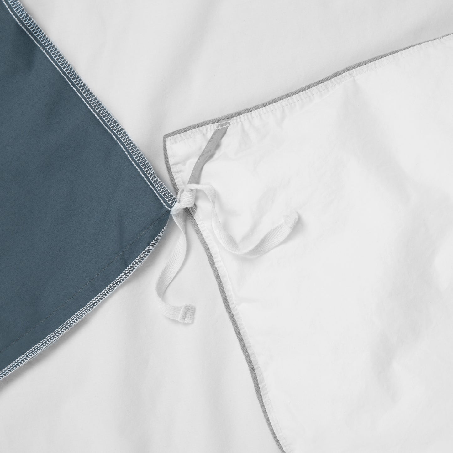 Close-up view of the corner ties on the Tuft and Needle Percale Duvet Cover Set ||color:canyon