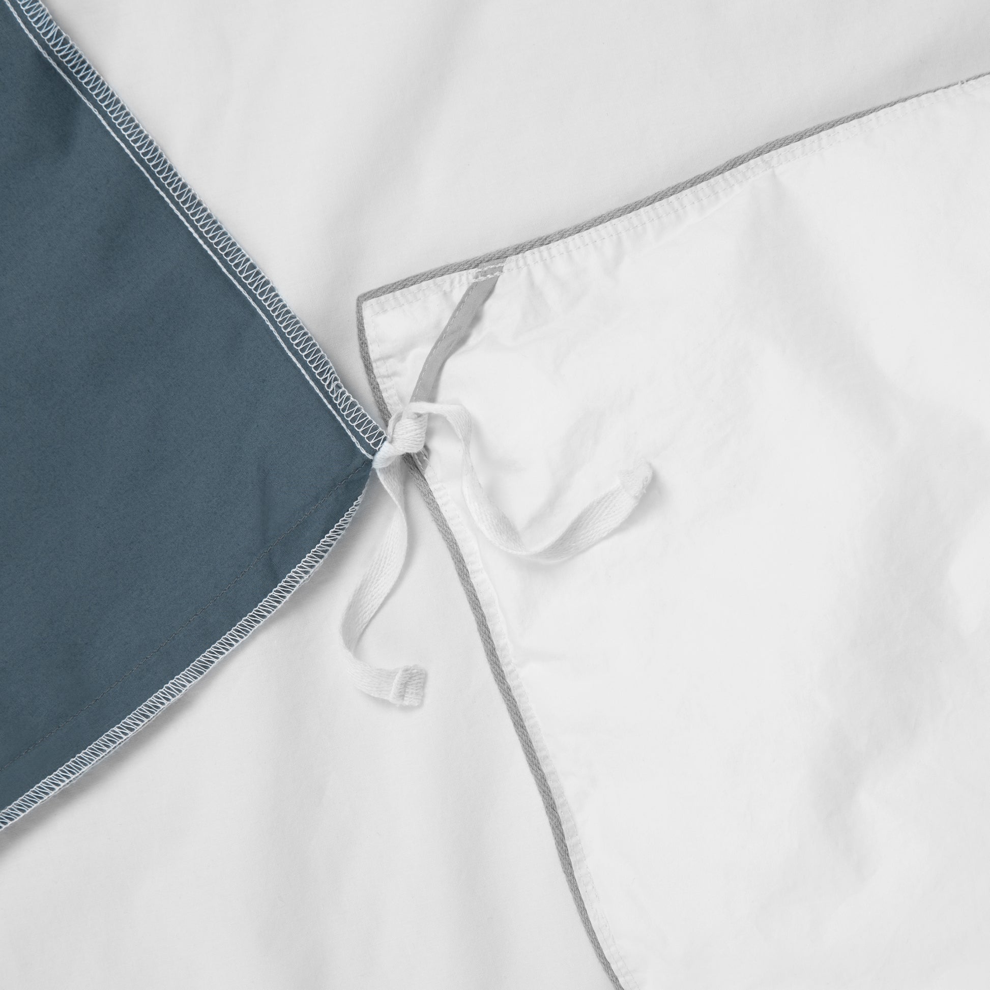 Close-up view of the corner ties on the Tuft and Needle Percale Duvet Cover Set ||color:canyon