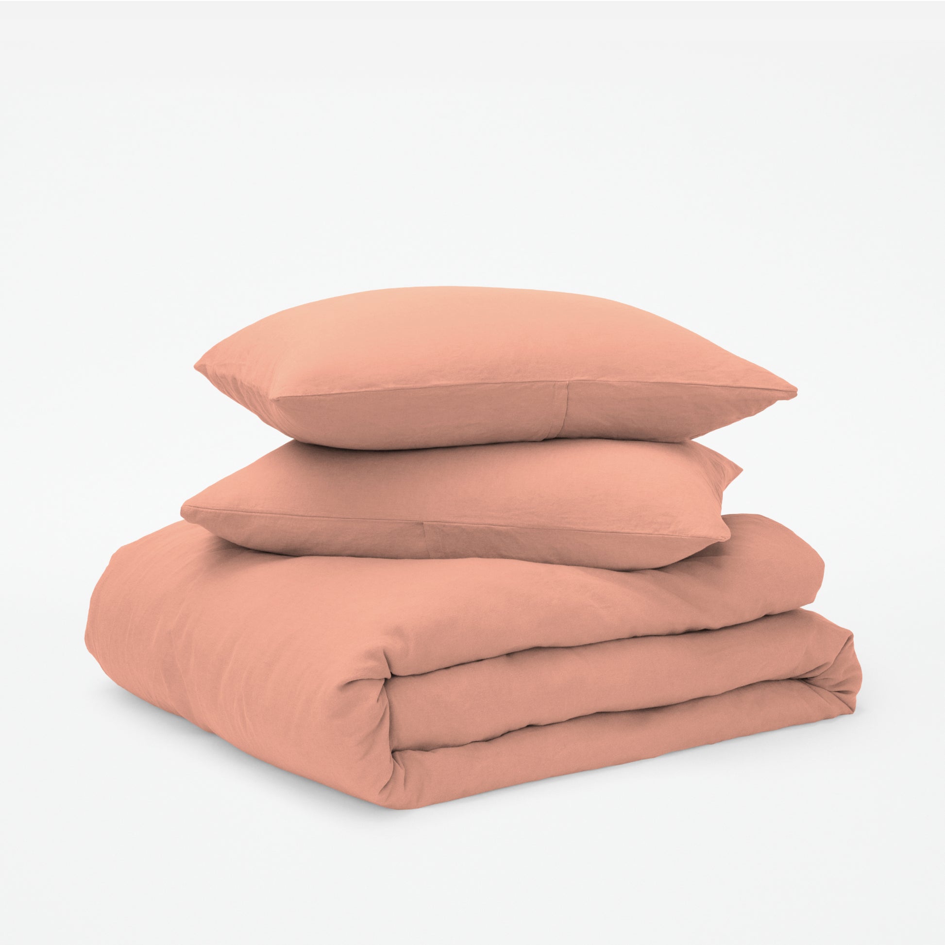 The Tuft and Needle Linen-Cotton Blend Duvet Set, 2 pillows stacked on 1 duvet covered blanket || color: Muted Clay
