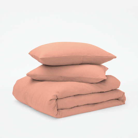 The Tuft and Needle Linen-Cotton Blend Duvet Set, 2 pillows stacked on 1 duvet covered blanket || color: Muted Clay
