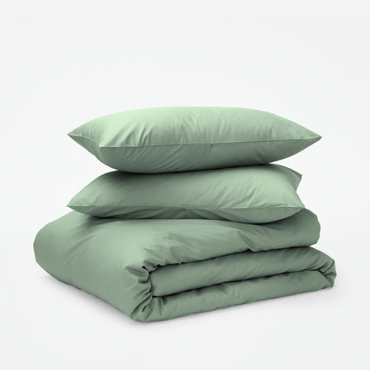 The Tuft and Needle Classic Percale Duvet Set, two pillows stacked on top of a sheet set || color: Sage
