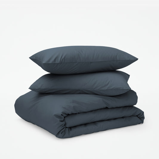 The Tuft and Needle Classic Percale Duvet Set, two pillows stacked on top of a sheet set || color: Slate
