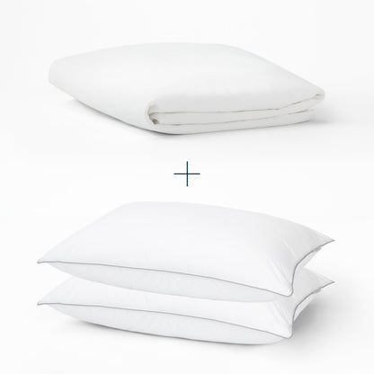 Tuft and Needle Mattress Protector and 2 down alternative pillows on top of each other with a plus sign in the middle