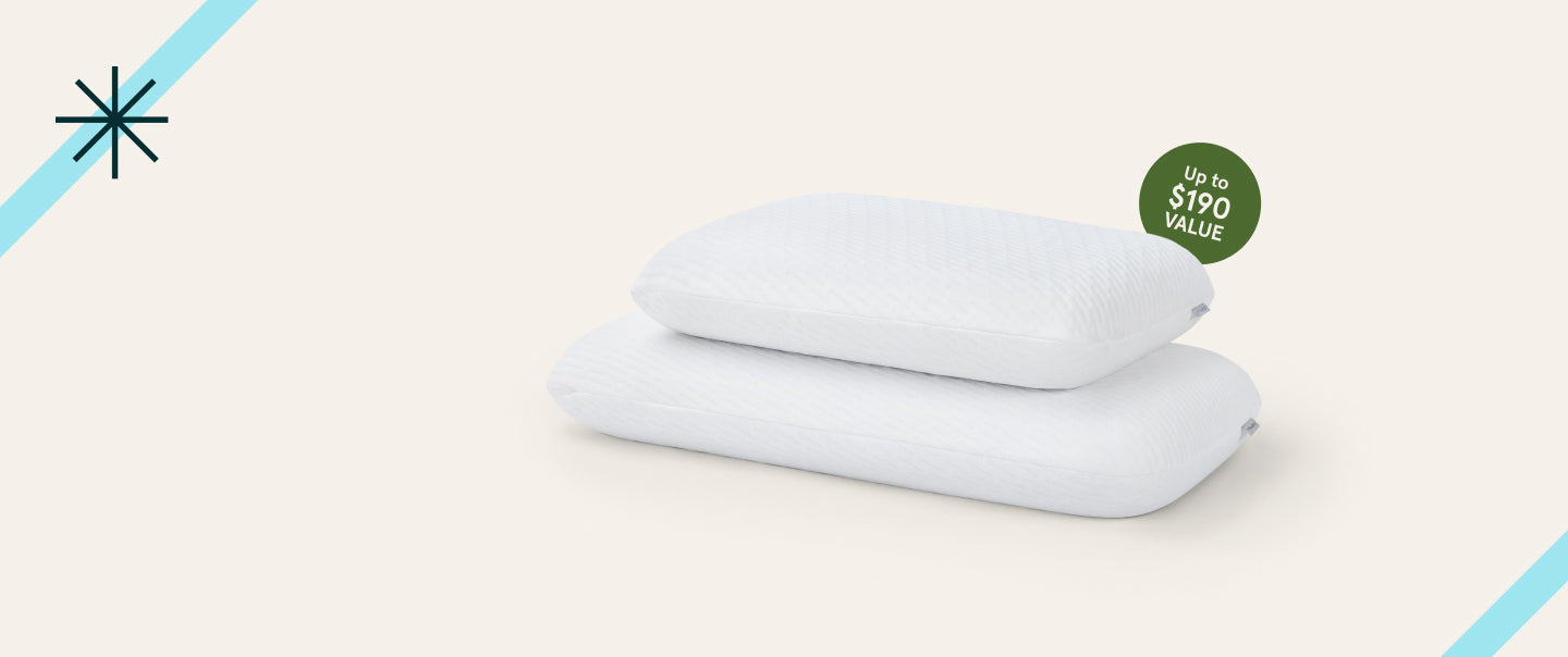 Two white pillows on a light beige background with a blue accent line.