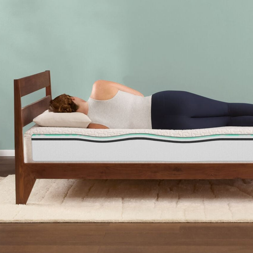 woman laying on her side on the T&N Original mattress showing the inside layers of the mattress