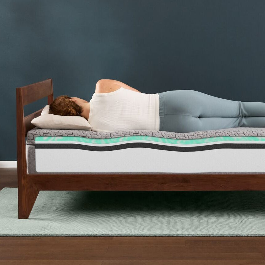 woman laying on her side on the T&N MInt mattress showing the inside layers of the mattress