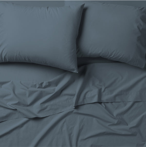 Tuft & Needle bedding, 2 pillows incased in 2 pillow cases on top of a 2 sheets.