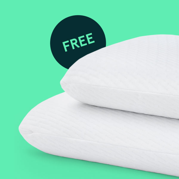 Two Tuft and Needle Original Foam pillows on top of each with a green background inclusive of a dark green badge that says free.