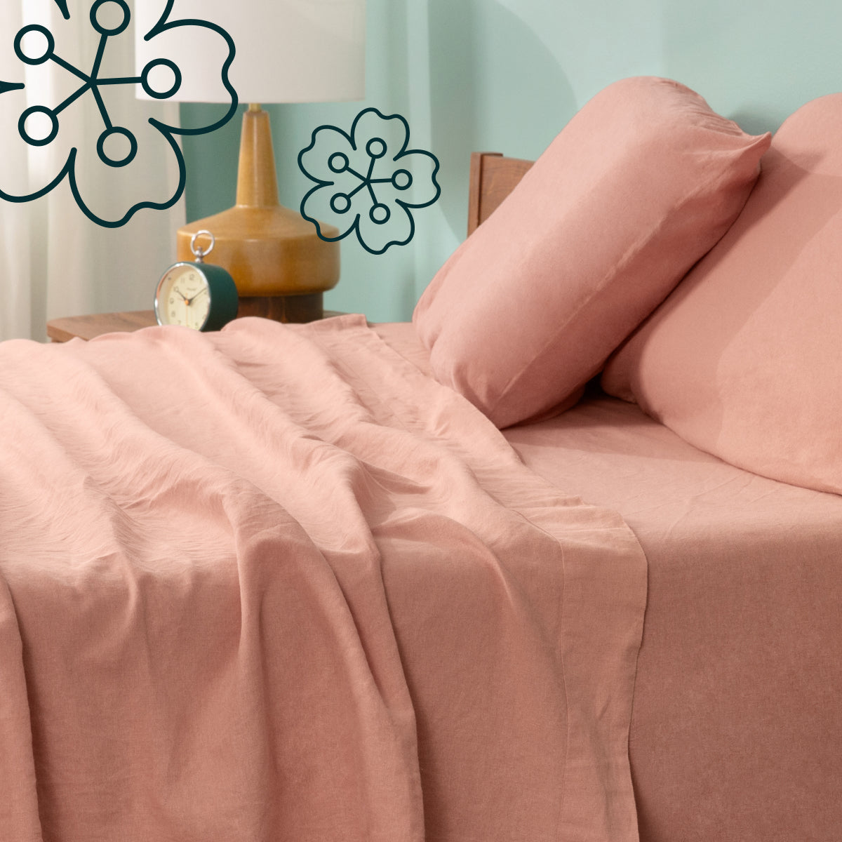 Pink Tuft and Needle bedding set on a bed with decorative elements in the background