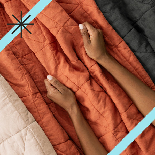 Woman's hands holding a Quilt