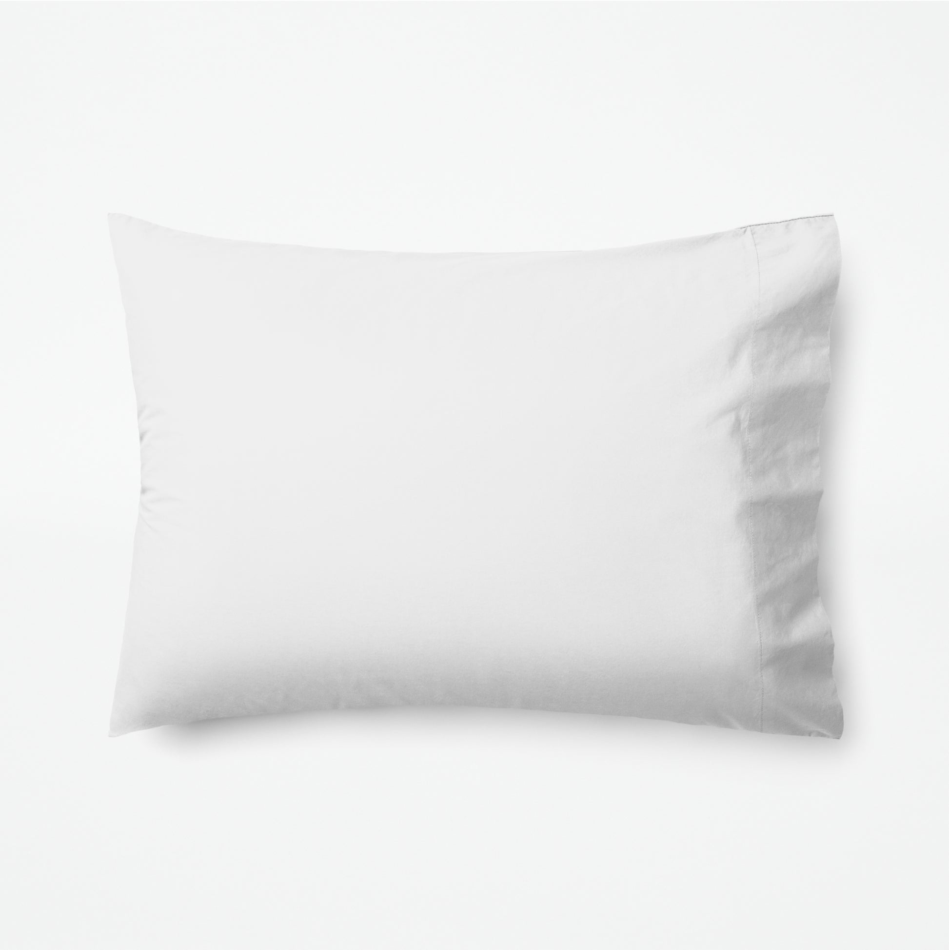 The Tuft and Needle Classic Percale Pillowcase Set, 1 pillow in a pillowcase showing in a horizontal position || color: Cloud
