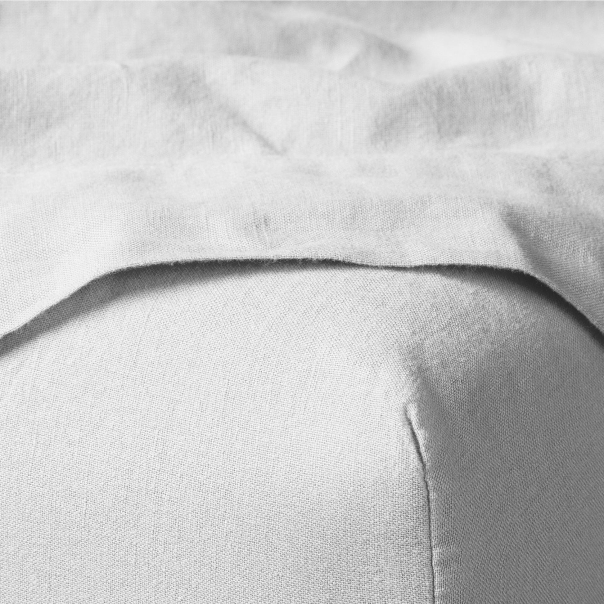 The Tuft and Needle Linen-Cotton Blend Sheet Set, corner of a mattress with both sheets showing || color: Cloud
