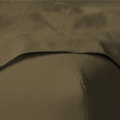 The Tuft and Needle Linen-Cotton Blend Sheet Set, corner of a mattress with both sheets showing || color: Martini Olive
