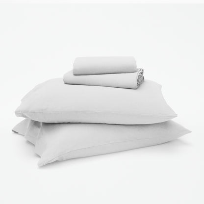 The Tuft and Needle Linen-Cotton Blend Sheet Set, 2 sheets stacked on 2 pillows || color: Cloud
