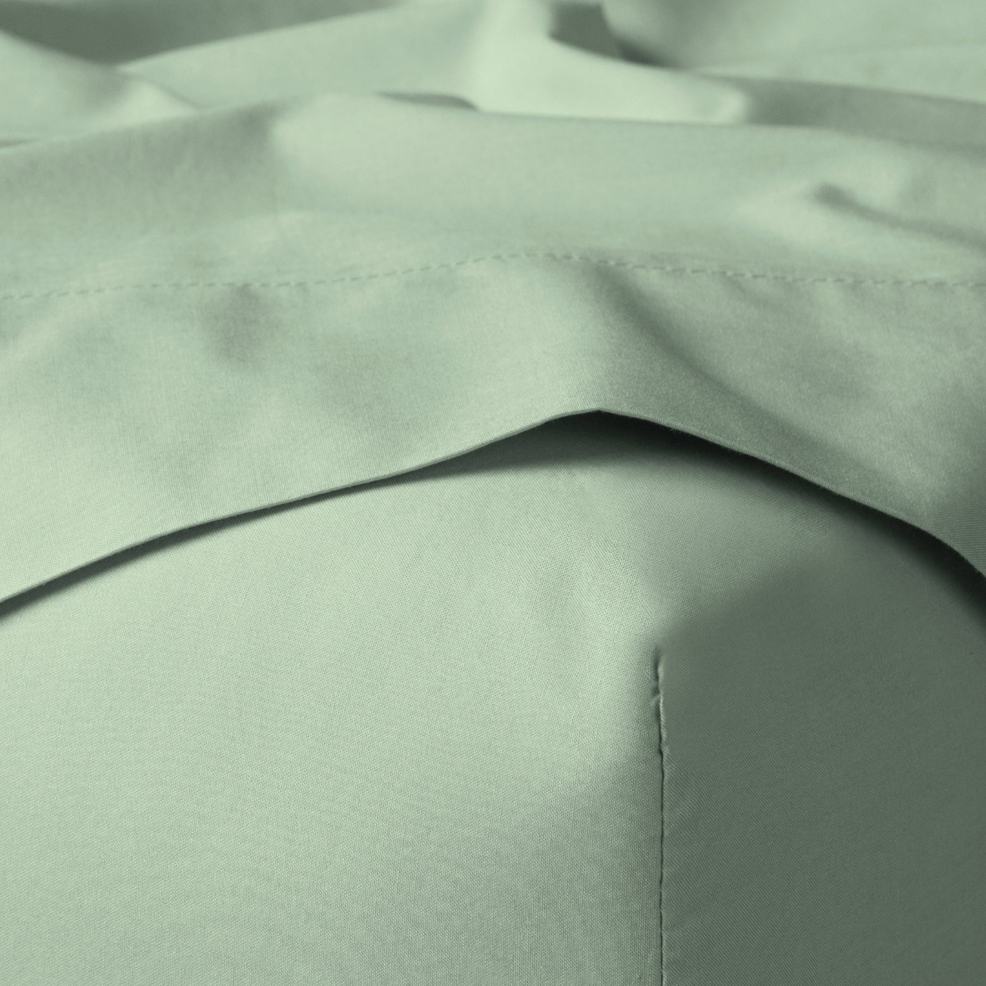 The Tuft and Needle Classic Percale Sheet Set, corner of a mattress with both sheets showing || color: Sage
