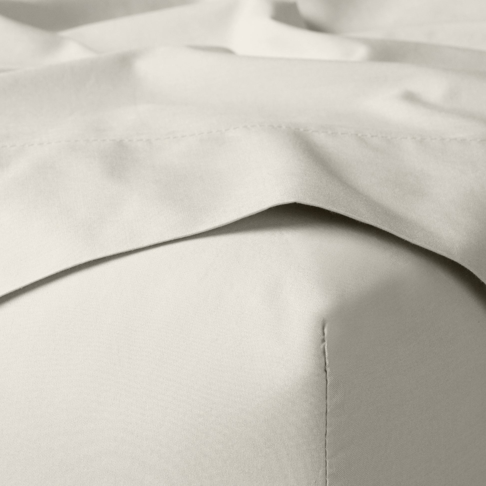 The Tuft and Needle Classic Percale Sheet Set, corner of a mattress with both sheets showing || color: Sand
