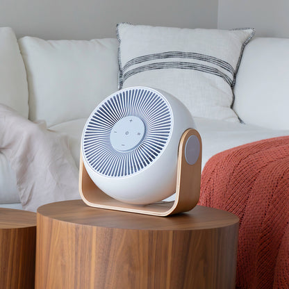 Snooz Breez Smart Bedroom Fan & White Noise Machine sitting on an end table