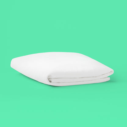 Folded white Tuft & Needle mattress protector
