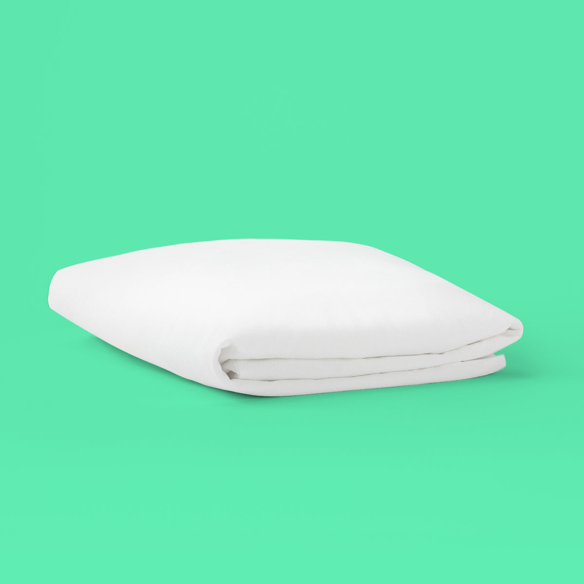 Tuft and needle mattress protector with a green background