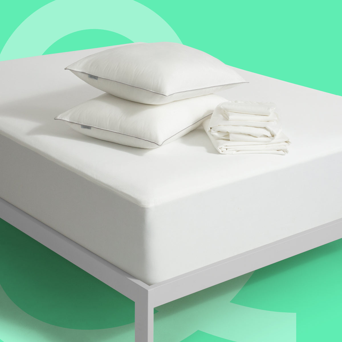 Tuft and Needle pillows, bed sheets and mattress protector sitting on a Tuft and Needle mattress.