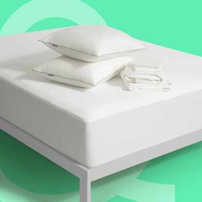 Tuft and Needle pillows, bed sheets and mattress protector sitting on a Tuft and Needle mattress.