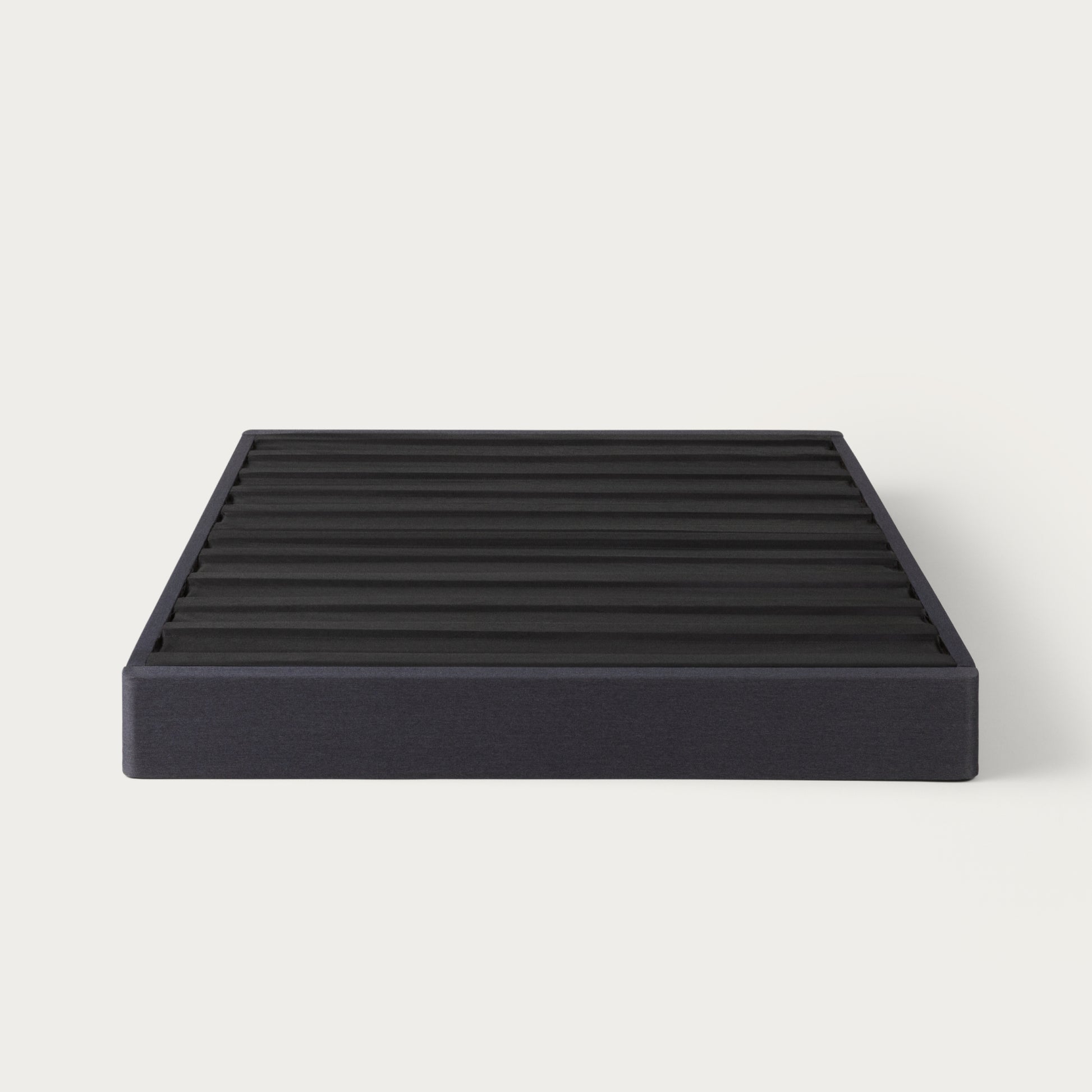 Tuft & Needle black colored mattress foundation on a white background