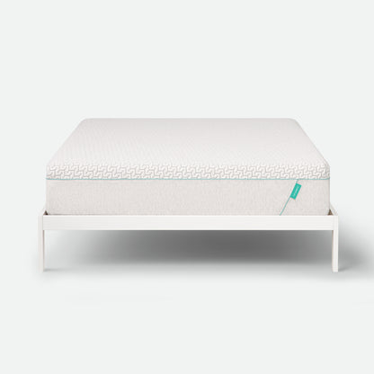 Tuft & Needle Mattress on a white stand with a white background