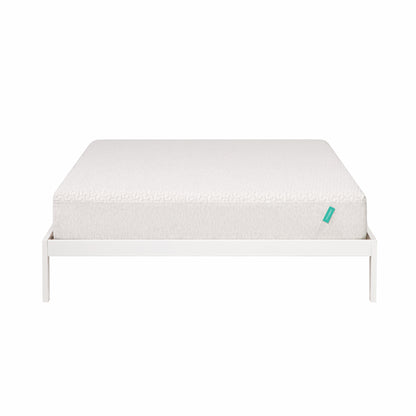 Foam mattress sites on a white bed frame. 
