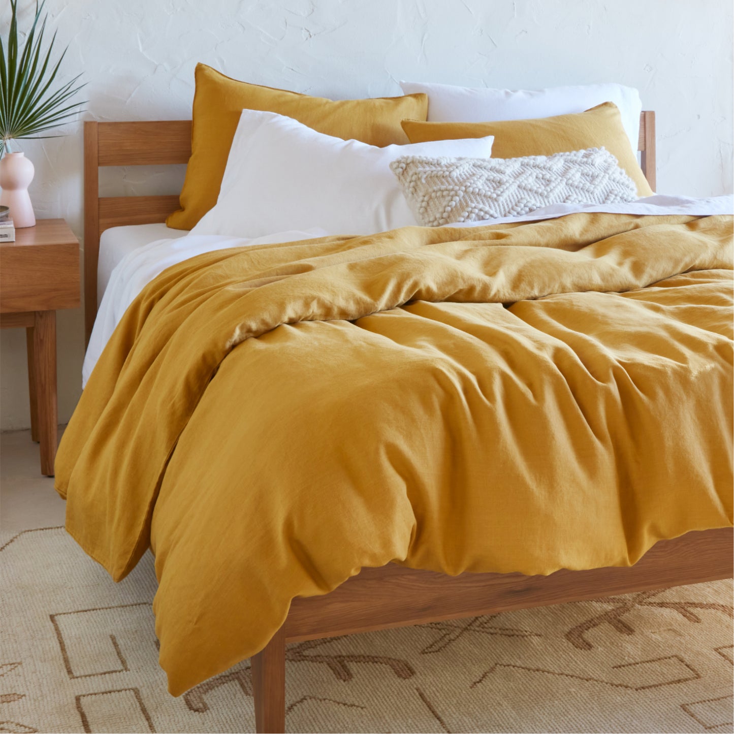 The Tuft and Needle Hemp Duvet Cover in a bedroom on a mattress||color:honeycomb