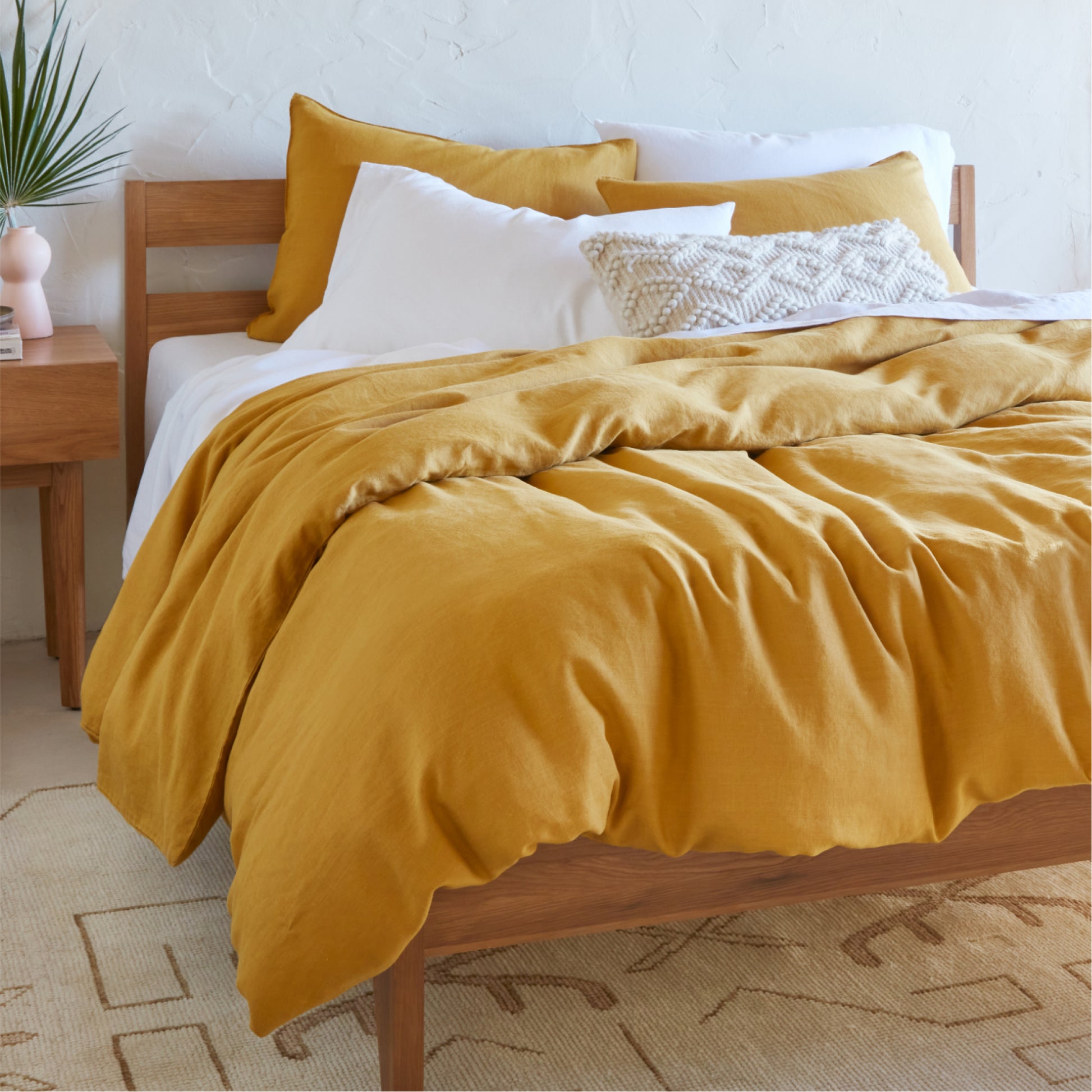 The Tuft and Needle Hemp Duvet Cover in a bedroom on a mattress||color:honeycomb