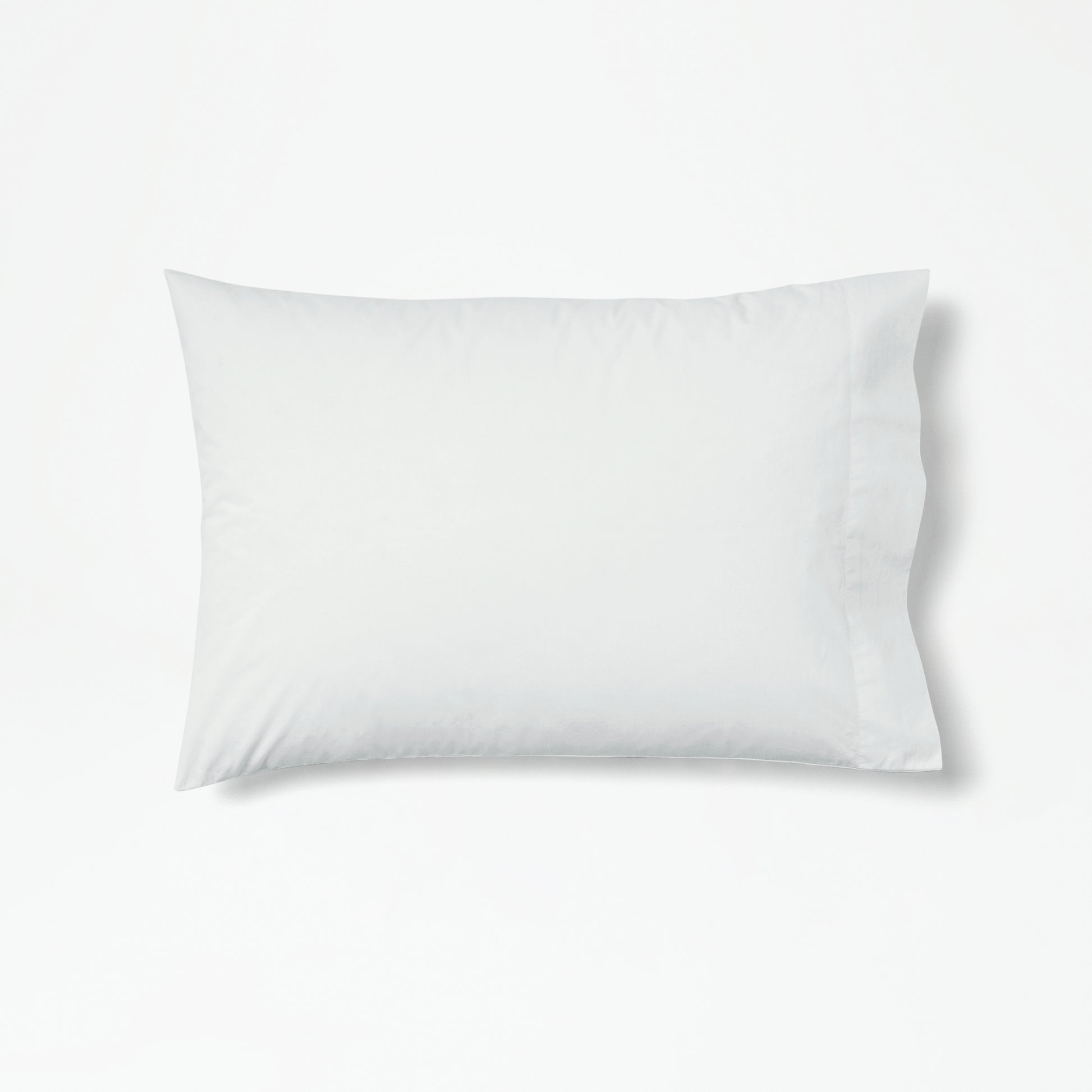 The Tuft and Needle Percale Pillowcase Set on one pillow||color:glacier