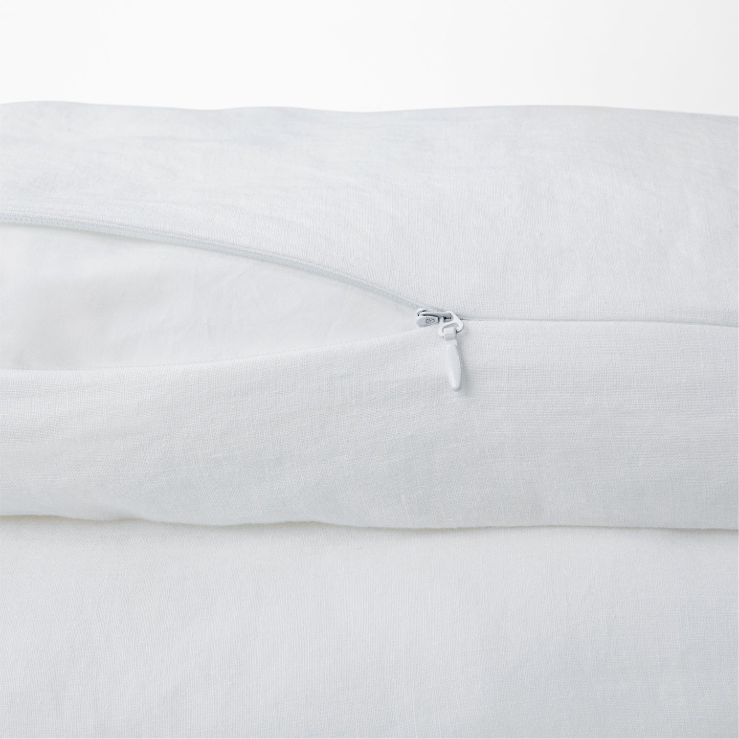 Close-up view of the zipper on the Tuft and Needle Hemp Duvet Cover ||color:honeycomb