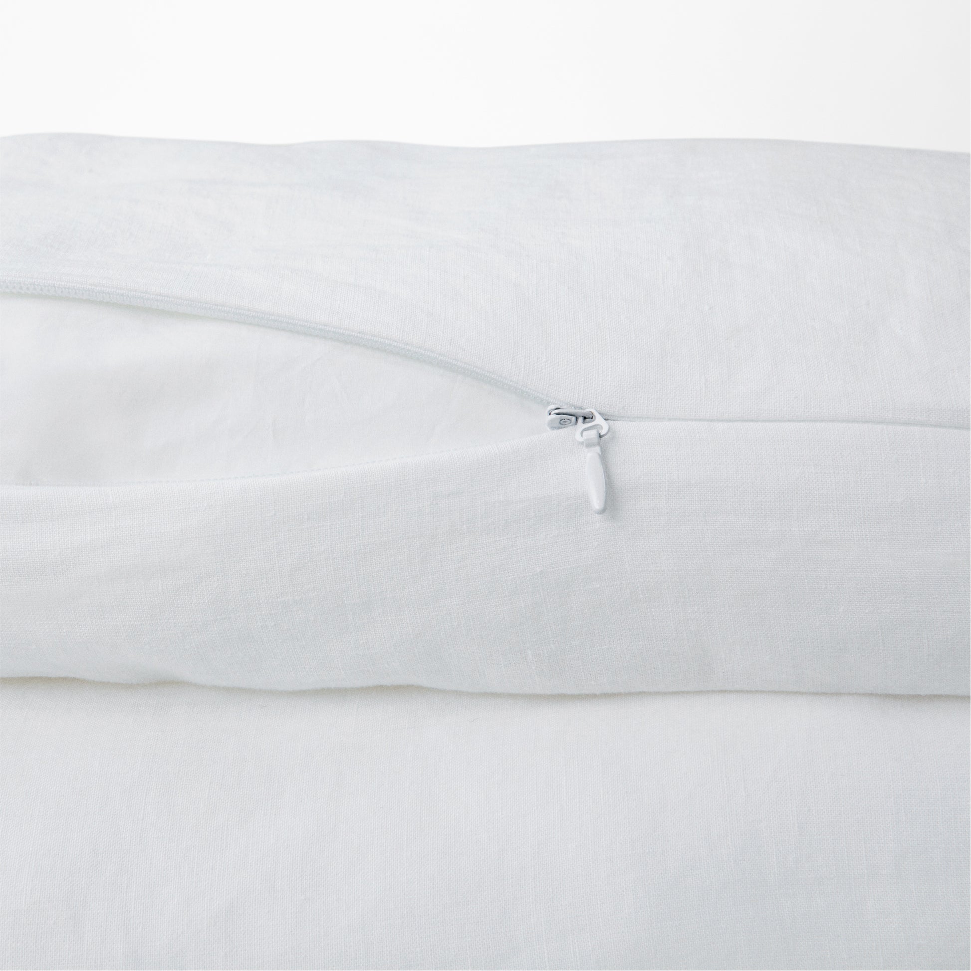 Close-up view of the zipper on the Tuft and Needle Hemp Duvet Cover ||color:honeycomb