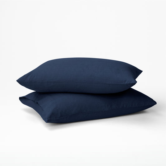 Two pillows dressed in the Tuft and Needle Hemp Pillowcase Set||color:midnight