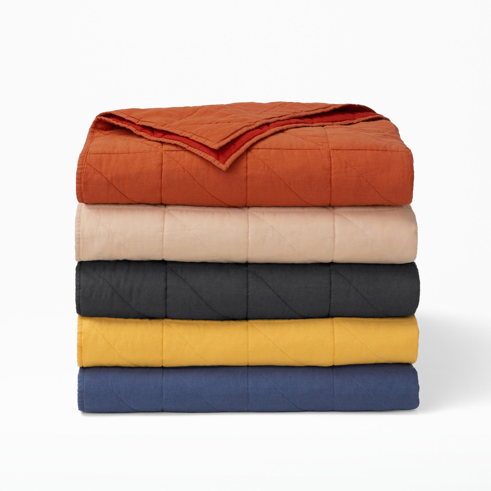 The Tuft and Needle Quilt folded and stacked||color:charcoal