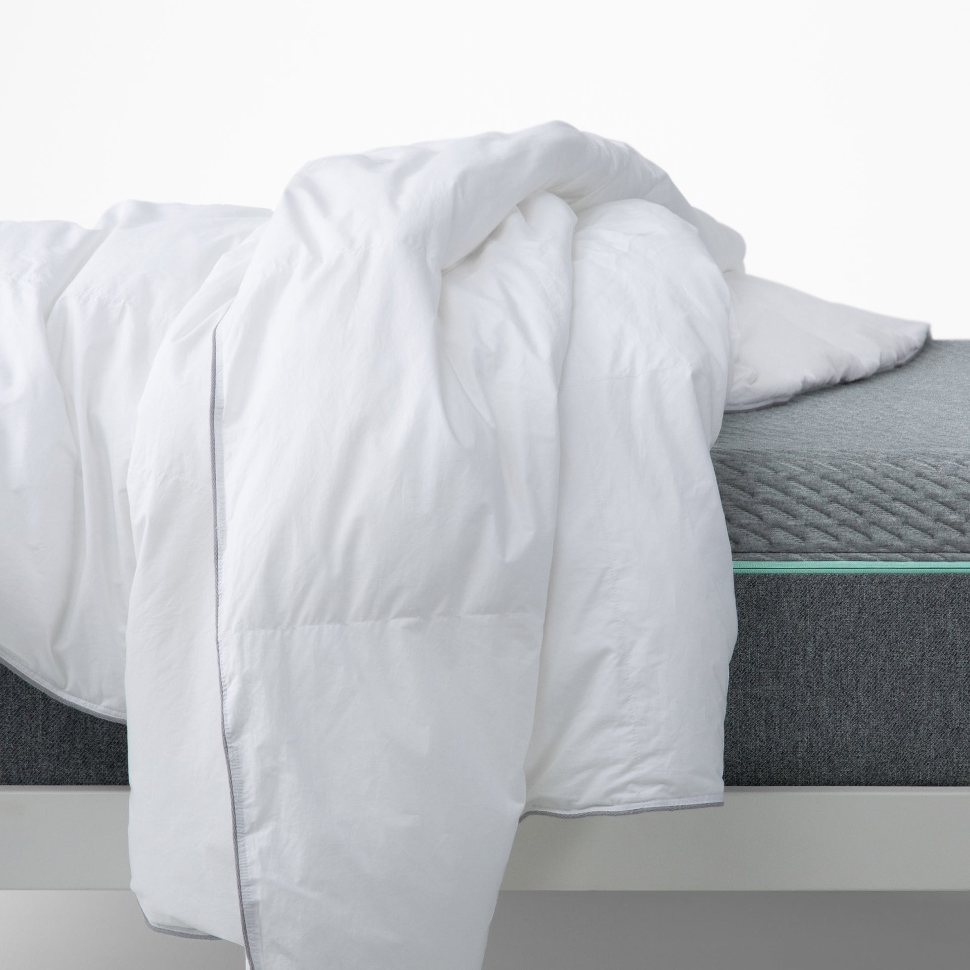 The Tuft and Needle Alternative Duvet Insert tossed on a bed in a bedroom||weight:light