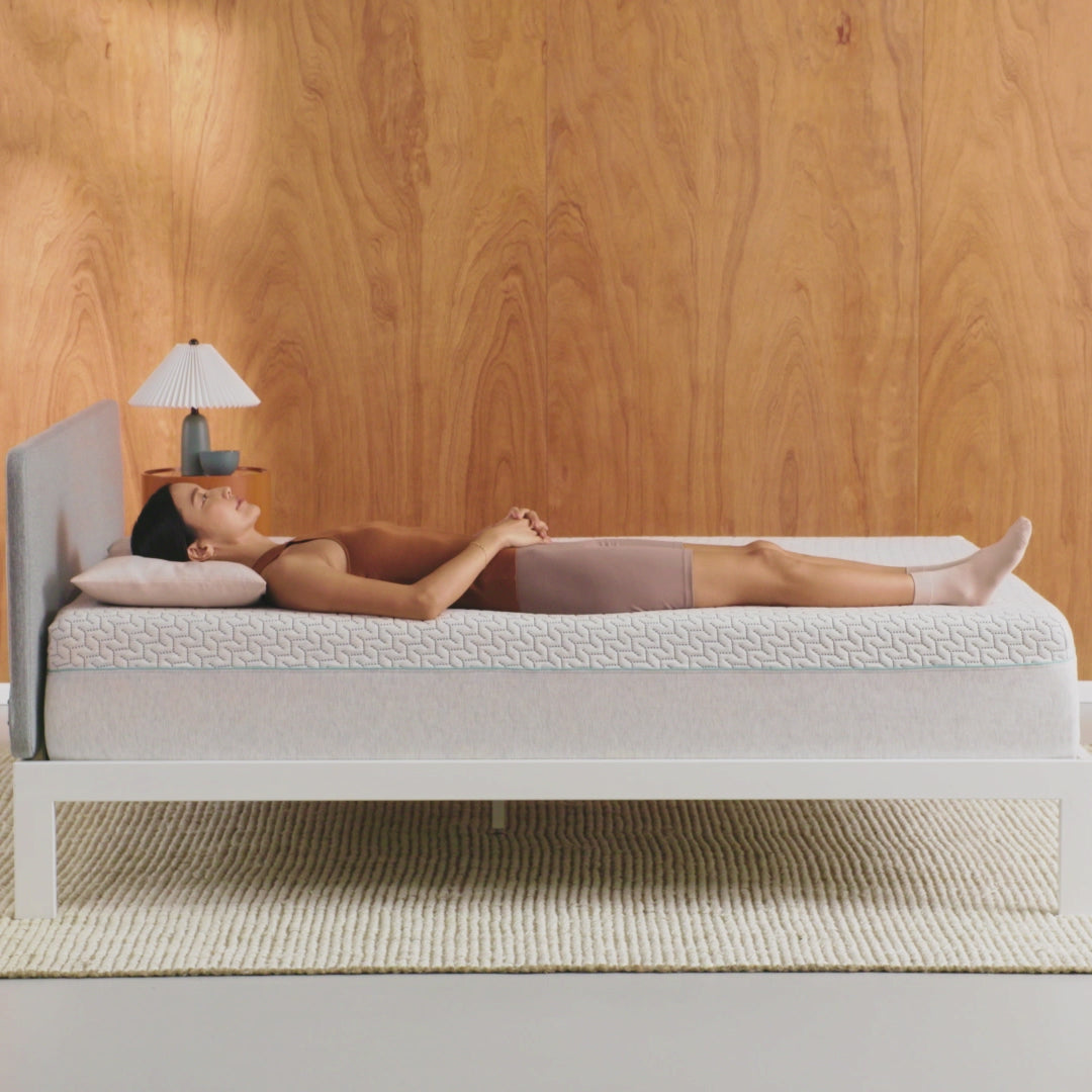 Tuft & Needle Original Hybrid Mattress short video showing a woman laying on her back the turning onto her left side