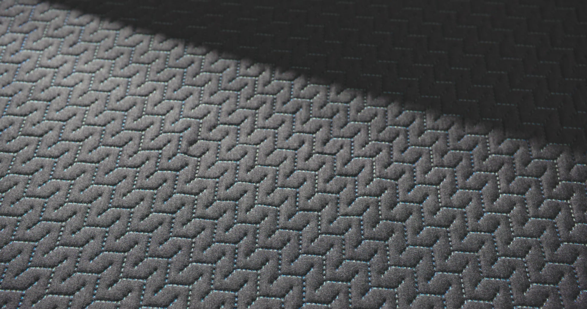 close up of a hand pressing into the top of the 14 inch hybrid mattress