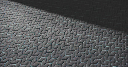 close up of a hand pressing into the top of the 14 inch hybrid mattress