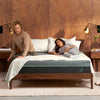 The Tuft and Needle T&N Mint Hybrid Mattress in a bedroom with 2 people