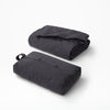 The Tuft and Needle Anywhere Travel Blanket folded on a white background||color:flint