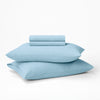 The Tuft and Needle Hemp Sheet Set stacked on top of two pillows||color:morning
